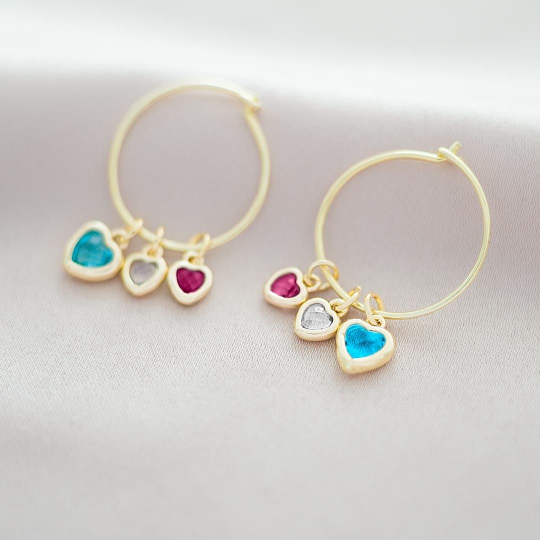 Pair of earrings showing the heart birthstone in a Aquamarine Diamond and Garnet Colourway