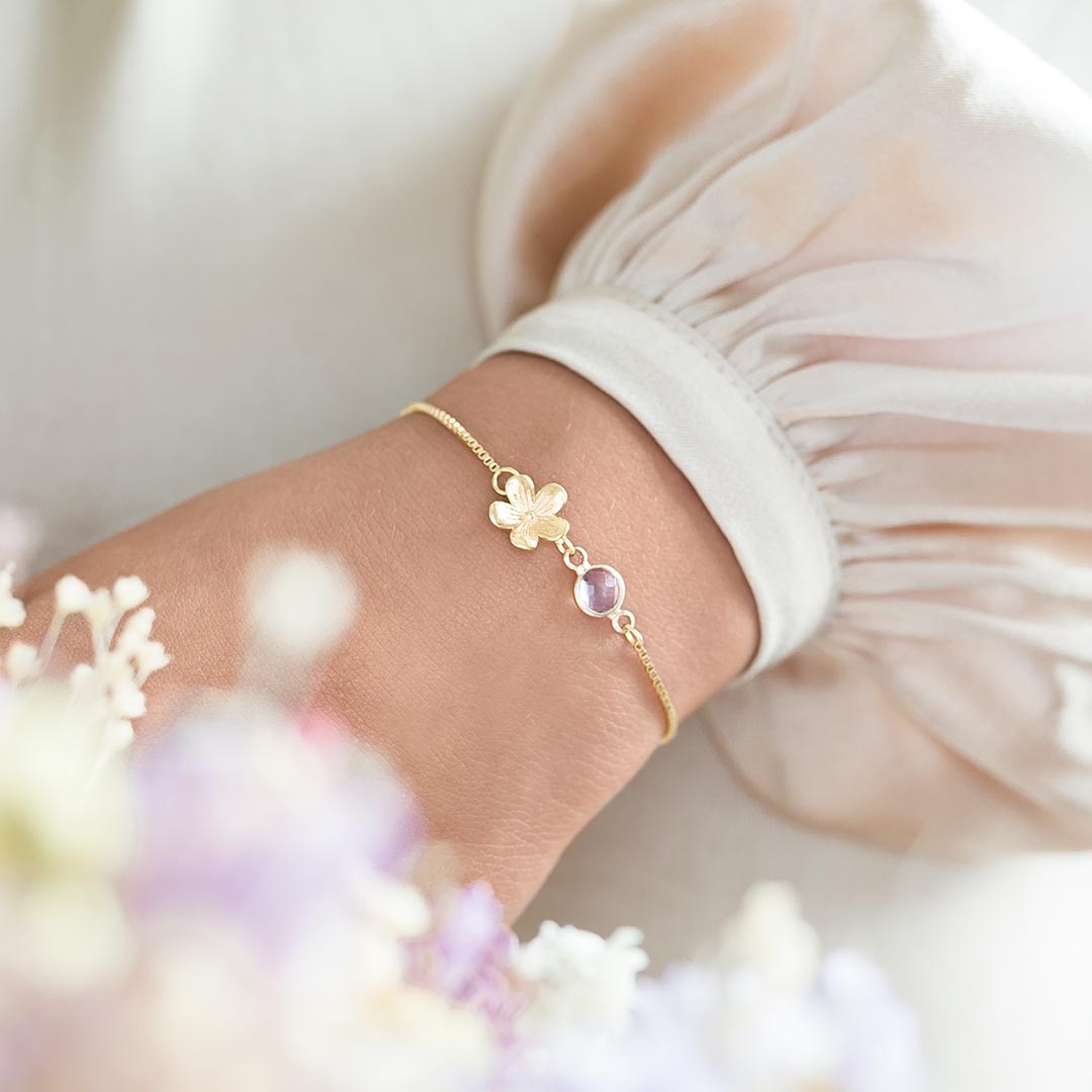 gold plated flower charm bracelet with birthstone on slider chain