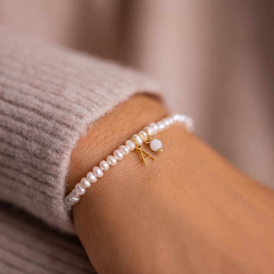 gold plated sterling silver letter and birthstone charm personalised pearl bracelet